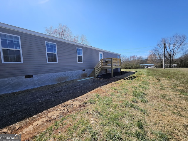 back of property with crawl space, a lawn, and a deck