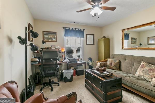 living room featuring carpet and ceiling fan