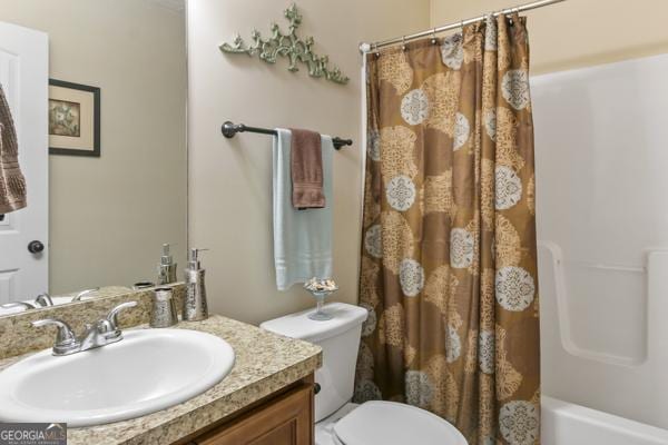 full bath featuring toilet, shower / tub combo with curtain, and vanity