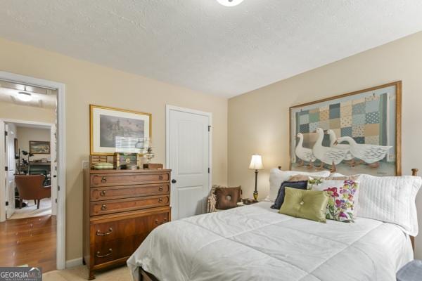 bedroom featuring baseboards and a textured ceiling