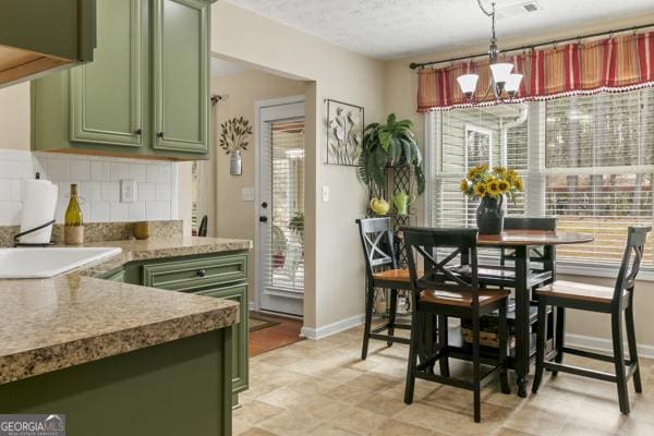 kitchen with green cabinets and plenty of natural light