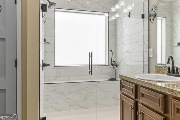 bathroom featuring a wealth of natural light and a shower stall