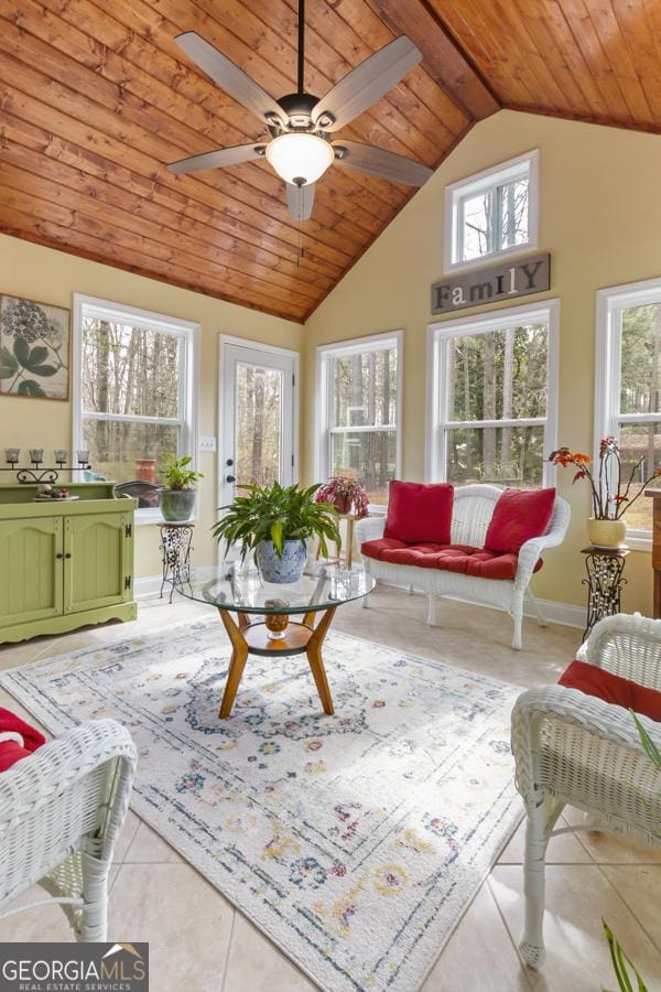 sunroom with wooden ceiling, a ceiling fan, and vaulted ceiling