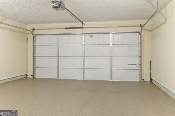 garage with a garage door opener and baseboards