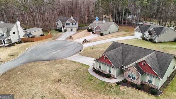 drone / aerial view with a view of trees and a residential view