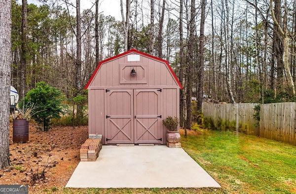 view of shed featuring fence