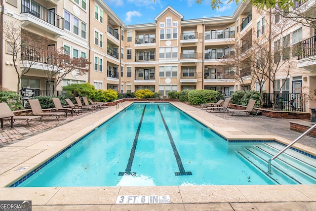 community pool with a patio area