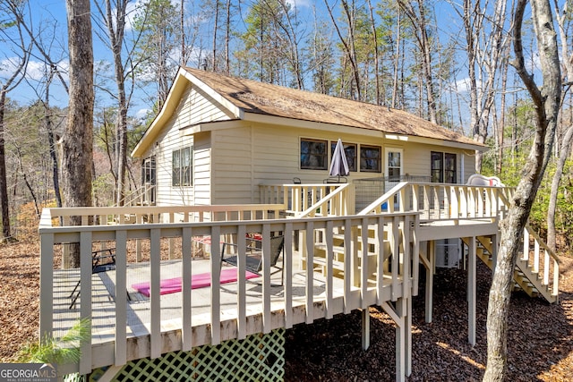 rear view of house with a deck and stairs