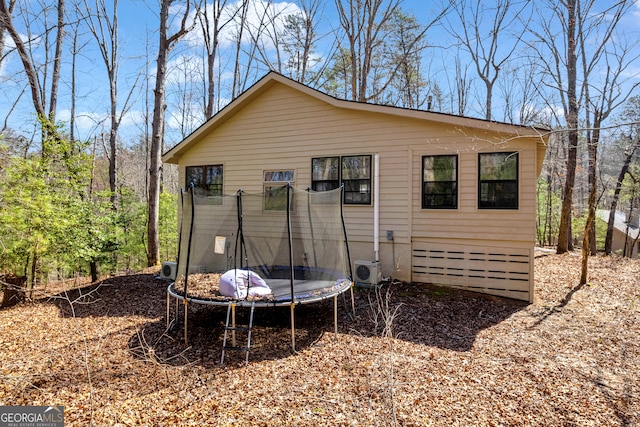 exterior space with ac unit and a trampoline