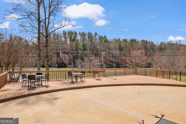 view of patio with outdoor dining space and a wooden deck