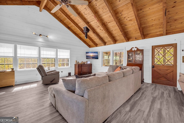 living area with beamed ceiling, wood finished floors, and wooden ceiling
