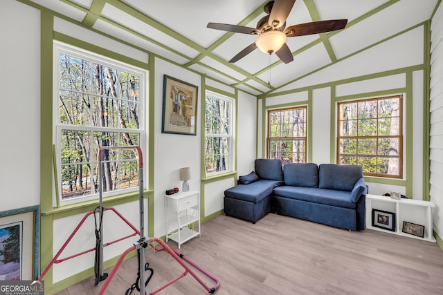 sunroom featuring a ceiling fan and vaulted ceiling