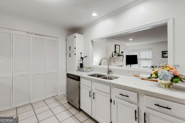 kitchen featuring light tile patterned floors, dishwasher, a textured ceiling, and a sink