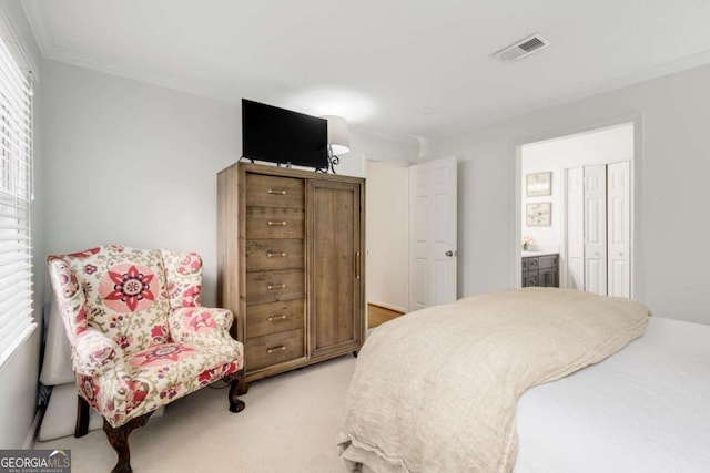 bedroom with crown molding, visible vents, and light carpet