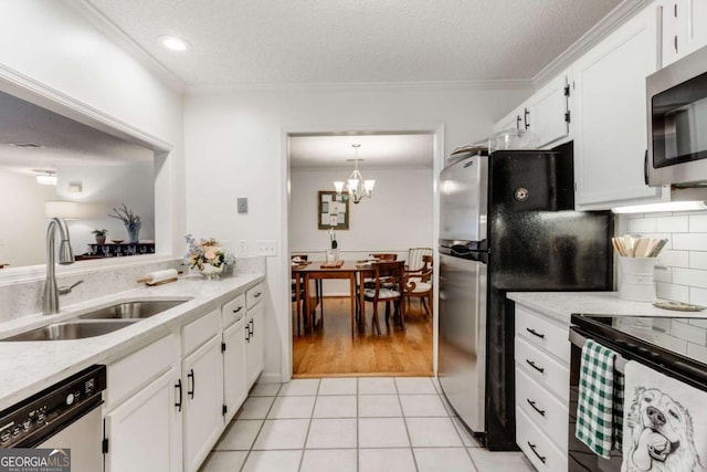 kitchen with crown molding, light tile patterned flooring, appliances with stainless steel finishes, and a sink