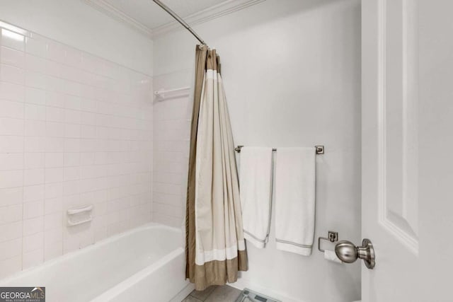 full bathroom with tile patterned flooring, crown molding, and shower / tub combo with curtain