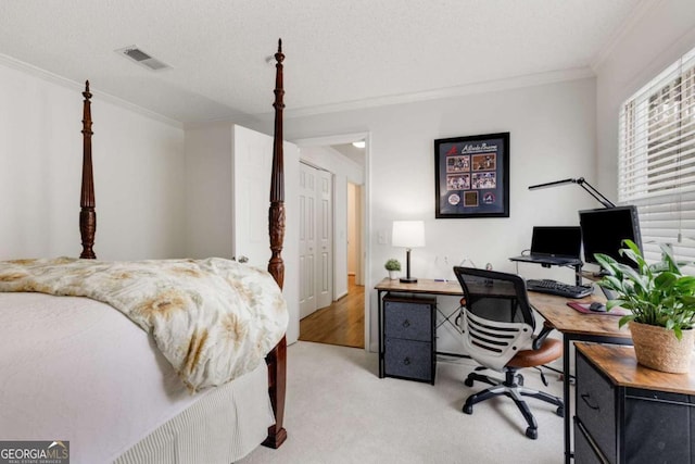 bedroom with a textured ceiling, ornamental molding, visible vents, and light carpet