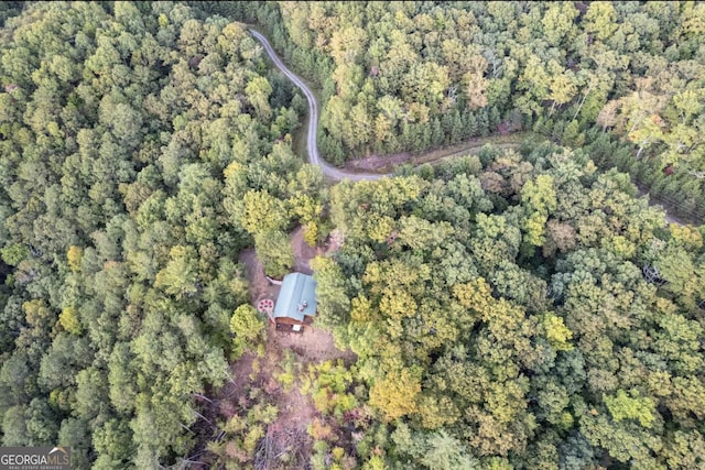 drone / aerial view with a wooded view