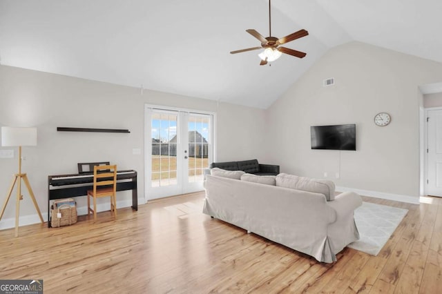 living room featuring visible vents, baseboards, french doors, wood finished floors, and high vaulted ceiling