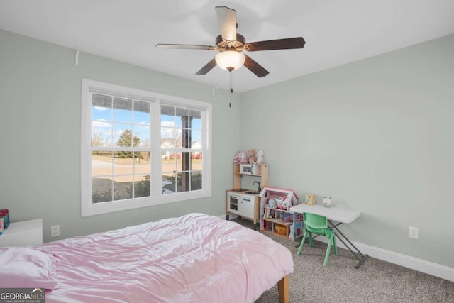 bedroom with ceiling fan, baseboards, and carpet floors