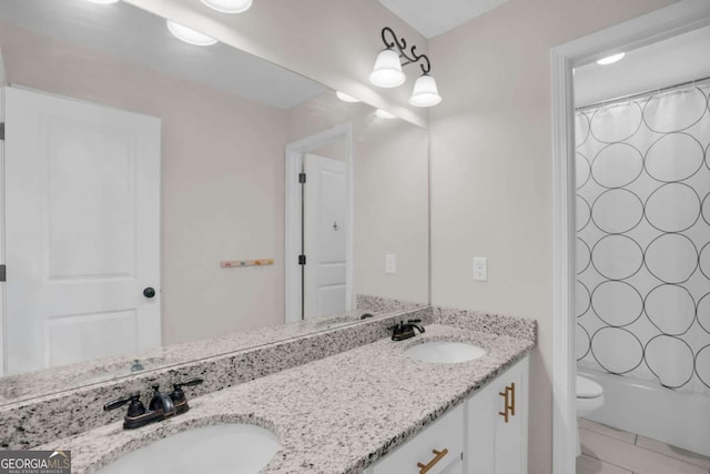 bathroom featuring a sink, toilet, double vanity, and shower / bath combination with curtain