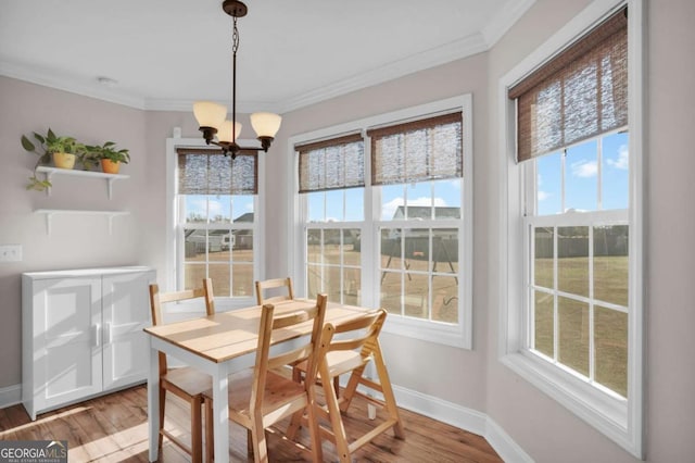 dining room with baseboards, light wood-type flooring, a chandelier, and ornamental molding