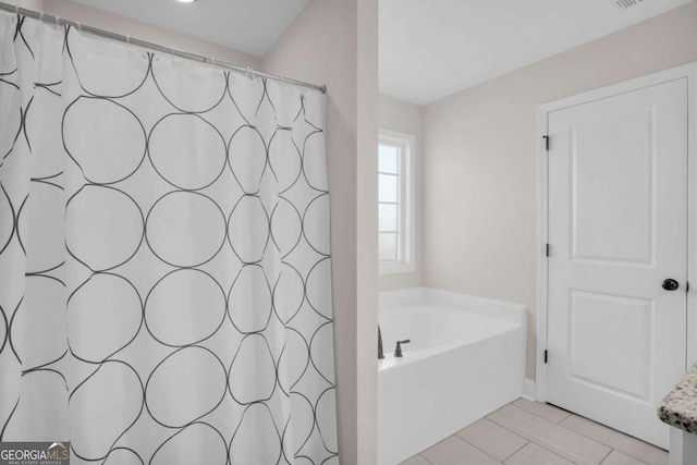 full bathroom with a shower with shower curtain, a bath, and visible vents