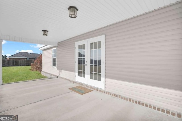 view of patio with french doors and fence