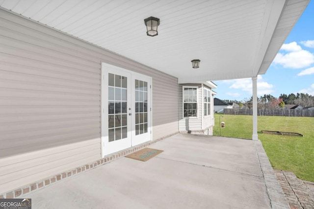 view of patio with french doors and fence