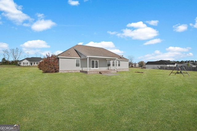 back of house with a lawn and fence