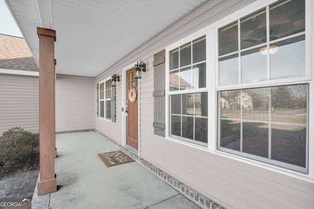 view of exterior entry featuring covered porch