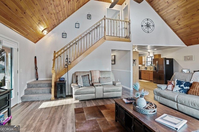 living room with wood finished floors, stairway, and wood ceiling