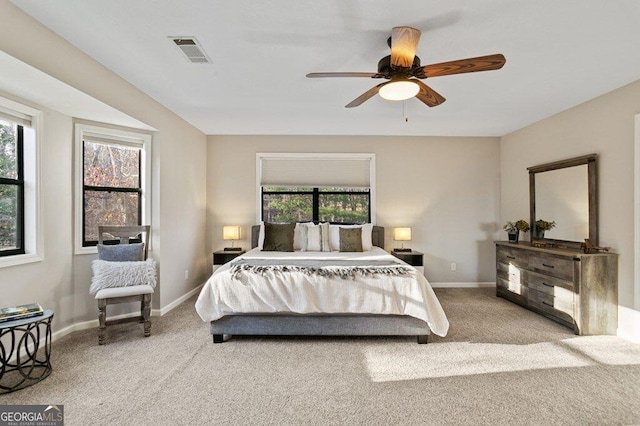 bedroom featuring visible vents, multiple windows, and carpet floors