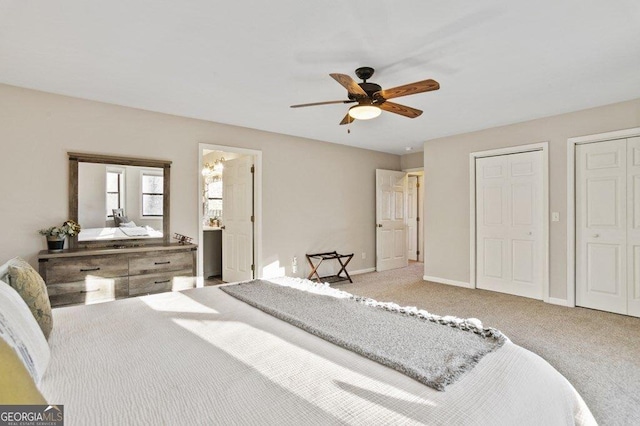 bedroom with baseboards, multiple closets, carpet, and ceiling fan