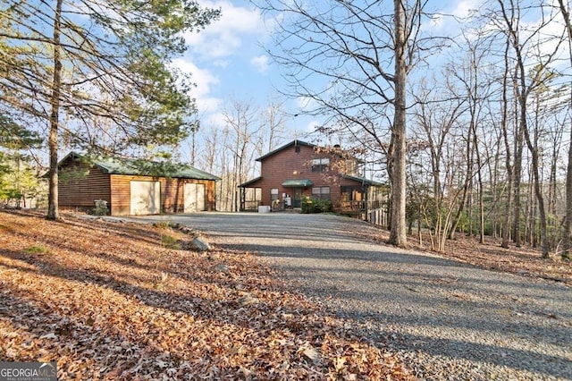 view of front of house with an outdoor structure and a garage