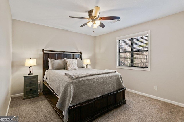 carpeted bedroom featuring visible vents, baseboards, and ceiling fan