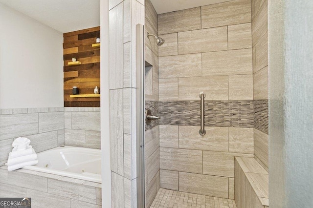 bathroom featuring a jetted tub and a stall shower