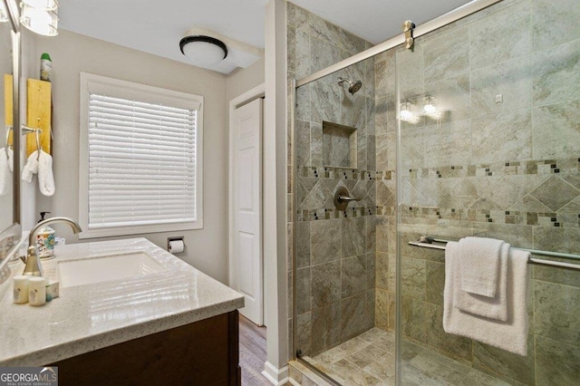 bathroom featuring a stall shower and vanity