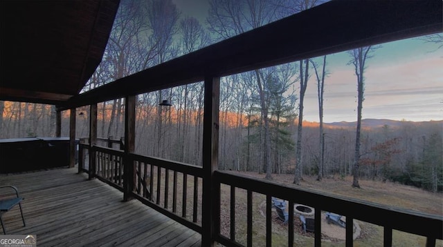 deck at dusk with a view of trees