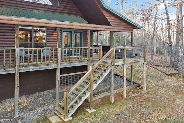 exterior space featuring stairway and metal roof