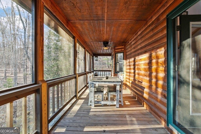 unfurnished sunroom featuring a wealth of natural light and wood ceiling