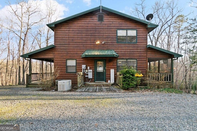 view of front of home with faux log siding and a porch