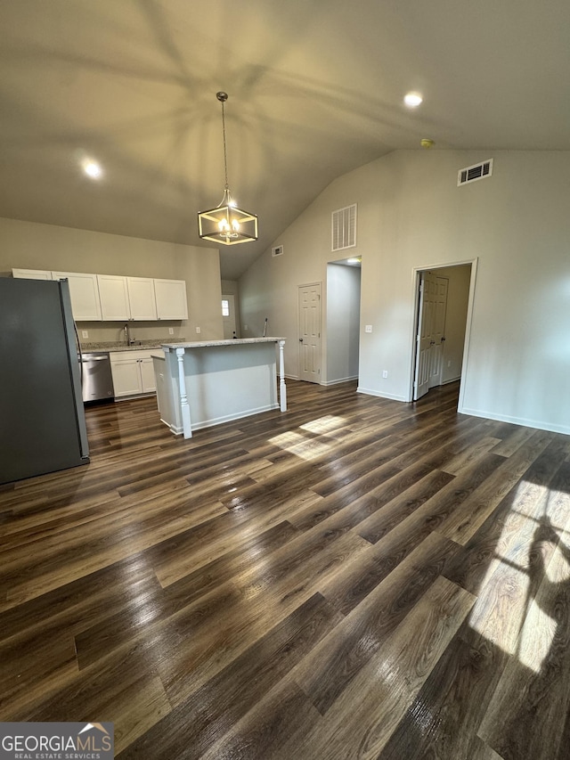 kitchen with visible vents, freestanding refrigerator, lofted ceiling, and stainless steel dishwasher