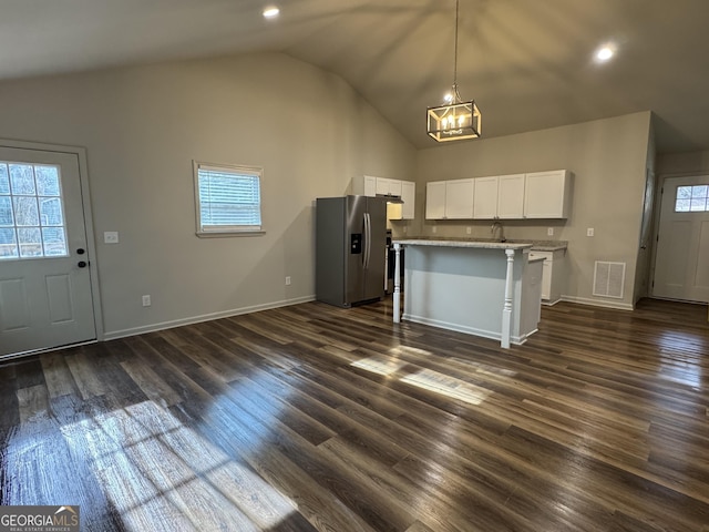 kitchen featuring visible vents, dark wood finished floors, white cabinets, stainless steel refrigerator with ice dispenser, and a wealth of natural light