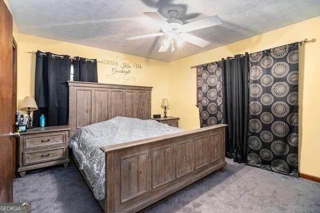 bedroom featuring ceiling fan and dark carpet