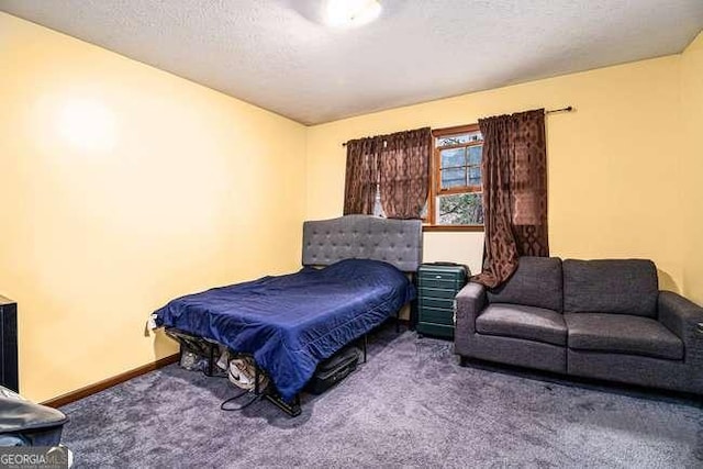 carpeted bedroom featuring a textured ceiling and baseboards