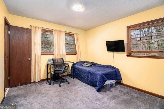 carpeted bedroom with baseboards