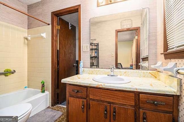 bathroom with vanity, toilet, and shower / bathtub combination