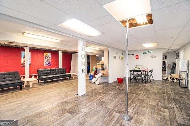 interior space featuring a drop ceiling and wood finished floors