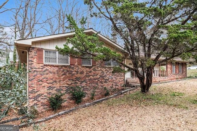 view of side of property with brick siding and board and batten siding